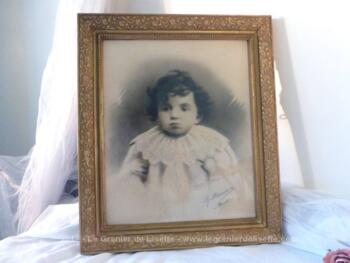 Ancien cadre en bois, de couleur doré avec photo d'un enfant triste.