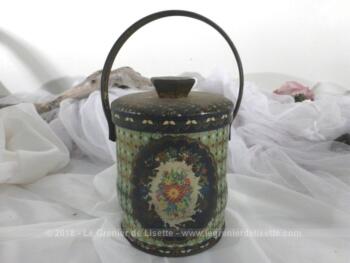 Ancienne boite en fer à la forme originale avec son couvercle et sa anse, sérigraphiée de dessins de fleurs.