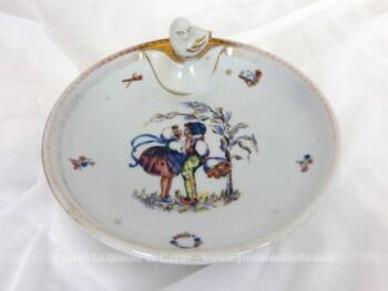 Ancienne assiette chauffante bébé porcelaine en porcelaine de Limoges avec dorures et un modèle de dessin rétro au centre.