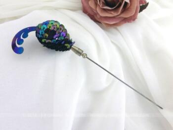 Voici une belle épingle à chapeaux en sequins de 14 cm de long dont la partie décorative est en sequins de couleur dominante bleu.