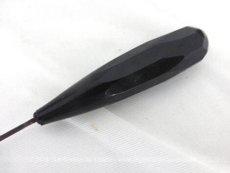 Sur 17 cm de long, voici une épingle à chapeaux avec une perle à facettes en verre noir en forme d'obélisque.