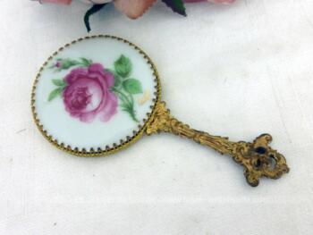 Adorable miroir face à main avec en décoration un écusson rond en porcelaine de Limoges décoré d'un belle rose fuchsia.
