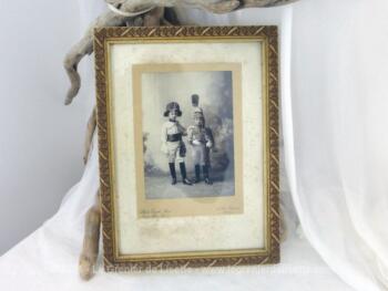 Cadre en bois avec décorations de 27 x 20 cm et sa photo du début du XX° de deux enfants habillés en militaire.