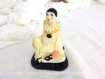 Adorable statuette vintage en plâtre d'un Pierrot assis avec son masque dans la main.