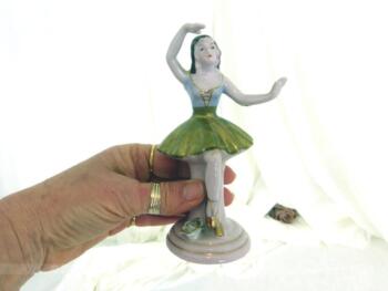 Adorable figurine en céramique d'une marquise danseuse à la jupe dorée sur 14.5 cm de haut sur piédestal rond.avec un bras au dessus de la tête.