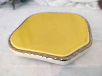 Sur 23 x 23 cm, voici un ancien dessous de plat jaune mimosas réalisé en Faïence de Salins avec une bordure en relief surligné de dorure.