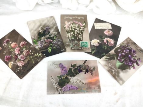 Six cartes postales anciennes avec de belles photos sépia représentant des bouquets de fleurs sur un fond sombre pour souhaiter une bonne fête et datant du début des années 1900.