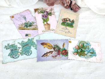 Voici un lot de six cartes postales anciennes aux contours dentelées sur papier pastel irisé ou nacré avec des dessins de fleur en relief  et datant du tout début du siècle dernier .