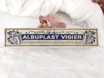 Ancienne boite en carton encore remplie de sa bande  "Albuplast Vigier" datant des années 50/60. Prévue pour de la décoration. Elle ne doit en aucun cas être utilisée .