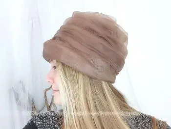 Voici un ancien chapeau en forme de toque composé par un entassement de différents plis de voile synthétique couleur chocolat au lait, pour former des étages. Fait main et facile à relooker si vous le souhaitez !