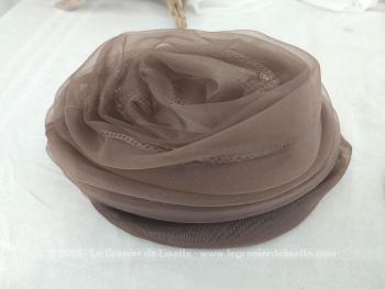 Voici un ancien chapeau en forme de toque composé par un entassement de différents plis de voile synthétique couleur chocolat au lait, pour former des étages. Fait main et facile à relooker si vous le souhaitez !