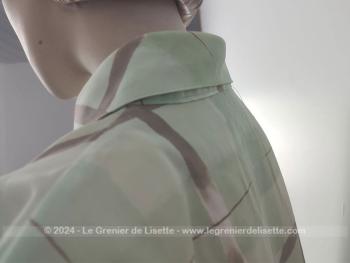 Voici un adorable chemisier vintage court à manches courtes, des années 80/90 très léger, en polyamide couleur vert d'eau et rayures grises et épaulettes intérieures en mousse portant l'étiquette de la marque 