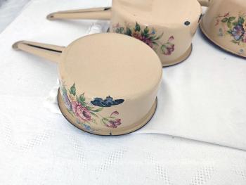 Voici un lot de 5 casseroles vintage des années 50/60 émaillées écru et décorées sur 2 faces de fleurs roses et bleues dans la tendance shabby avec de beaux éclats d'émail pour un effet très authentique du temps passé.