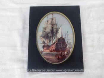 Sur 17 x 21.5 x 1 cm, voici un cadre bien original servant de marie-louise à une image ovale d'une scène du XVIII° de bataille navale avec de grands navires.