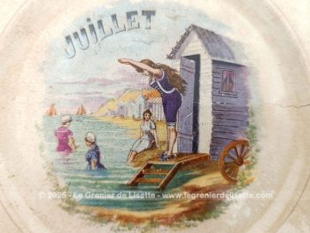 Datant de la fin XIX° ou début XX°, voici une ancienne assiette à dessert évoquant le mois de Juillet avec les Bains de Mer de cette époque, estampillée 