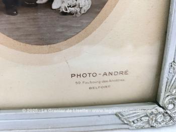 Sur 27 x 21 x 1cm, voici un cadre en bois peint couleur vieil argent  avec des fleurs en reliefs aux angles et  mettant en valeur une photo d'un mariage du début du siècle.  Tout dans ce cadre nous transporte avec nostalgie dans le monde vintage des années 30!