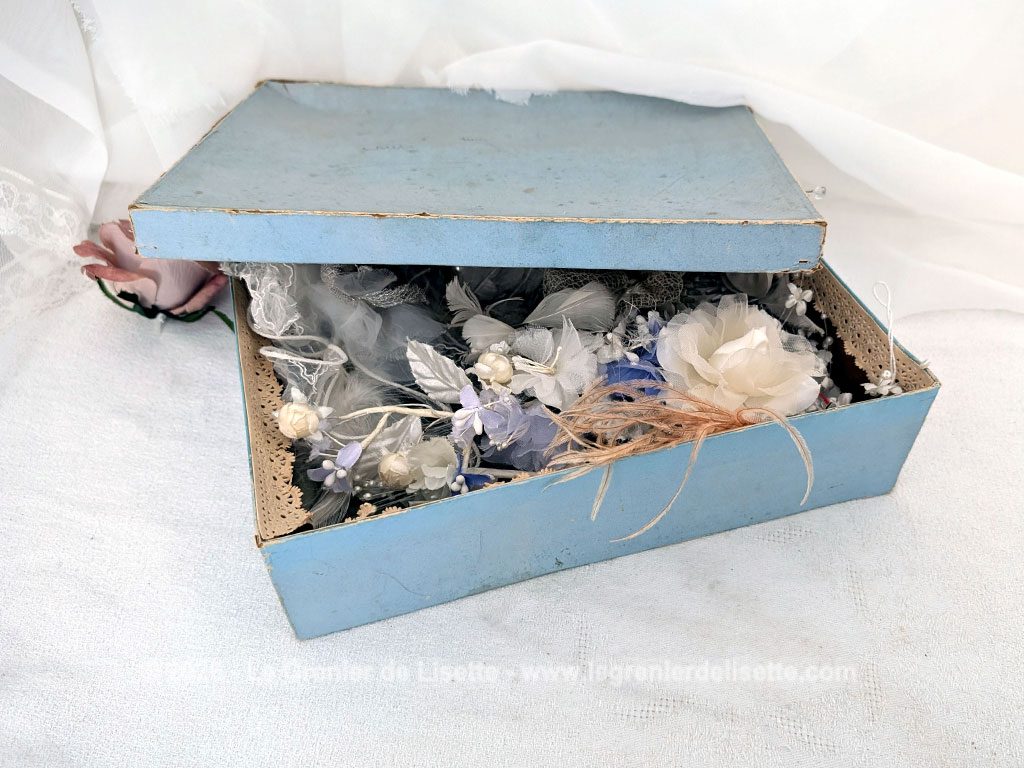 Dans une ancienne boite en carton habillée de dentelle en papier et remplie d'accessoires de mariée, anciens ou vintages, pour cheveux et coiffures. Plumes, perles et et tulles au rendez-vous !