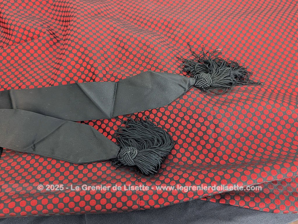 Voici une véritable veste d'intérieur pour homme en tissus satiné jacquard rouge et noir décoré de large bandes de satin noir et portant l'étiquette de la célèbre maison des maitres-tailleur "Lacazes Frères" à Lourdes. Une très belle pièce vintage !