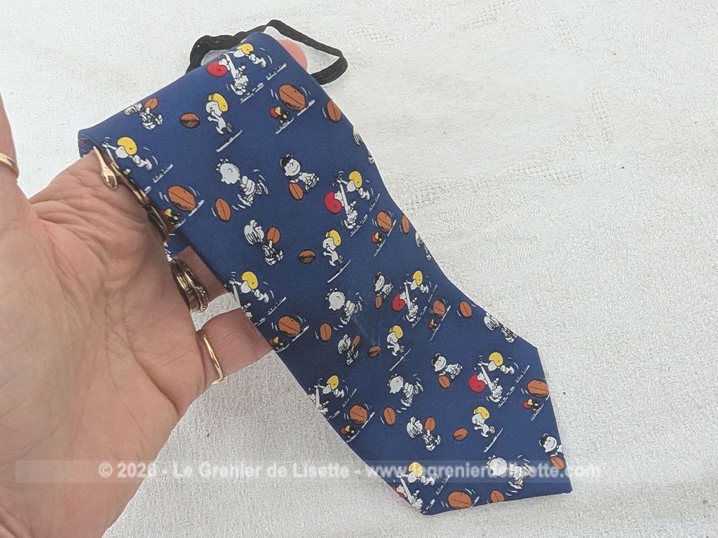 Pour garçonnet, voici une petite cravate vintage en 100% soie pour les fans de la bande à Snoopy, avec les personnages cultes comme Charlie Brown ou Lucy en pleine action sur un terrain de rugby. Facile à ajuster avec son système d'attache à élastique réglable.