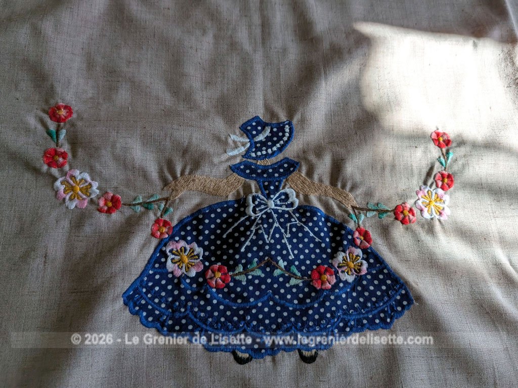 Sur 150 x 210 cm, voici une magnifique et grande nappe au look rétro et champêtre richement ornée de personnages aux robes en incrustations de tissu bleu à pois finement brodées. Idéale pour apporter une touche romantique et authentique à vos repas de famille.
